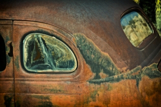 Rust-colored antique car inside Desert Ranch